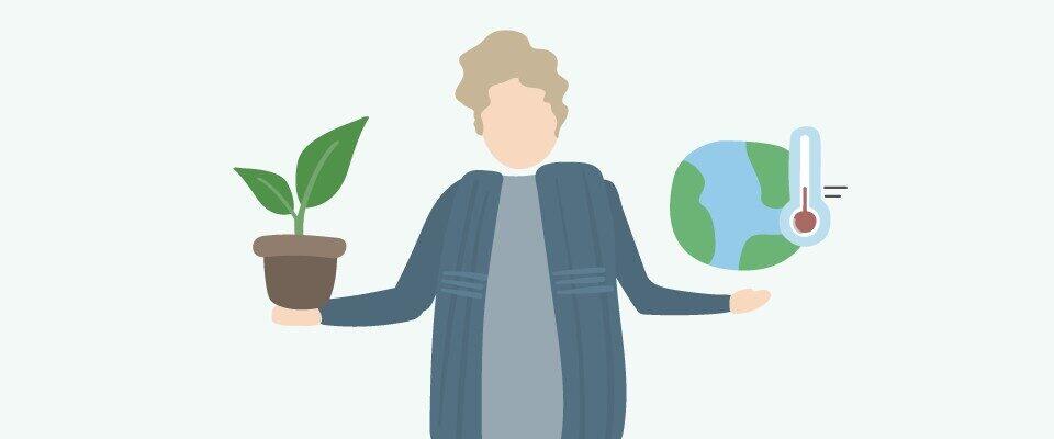 Man holds globe and plant